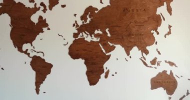 Wooden world map slow motion zoom in on USA in elegant modern room wall. High quality 4k footage