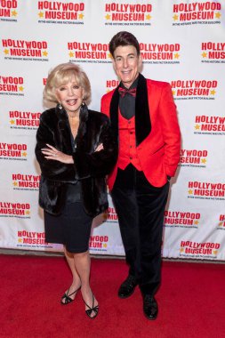 Actress Ruta Lee, TV Personality Bj Korros attend The Hollywood Museum Unveiling Of Film Legend Mary Pickford's Ball Gown at The Hollywood Museum, Los Angeles, CA March 4, 2023