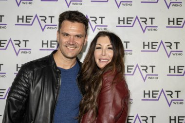 Actor Kash Hovey, Film Producer Wendy Benge attend J. Michael Arnoldi Birthday Bash and Toy Drive featuring Performance of G Tom Mac at Heart WeHo Night club in West Hollywood, Los Angeles, CA December 9, 2023 clipart