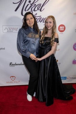 Aktris Nikol Strong ve annesi, 17 Aralık 2023 'te Porsche Downtown, Los Angeles' taki Oyuncaklar Yardım Gecesi ve Nikol Strong 'un Doğum Günü Partisi' ne katıldılar.