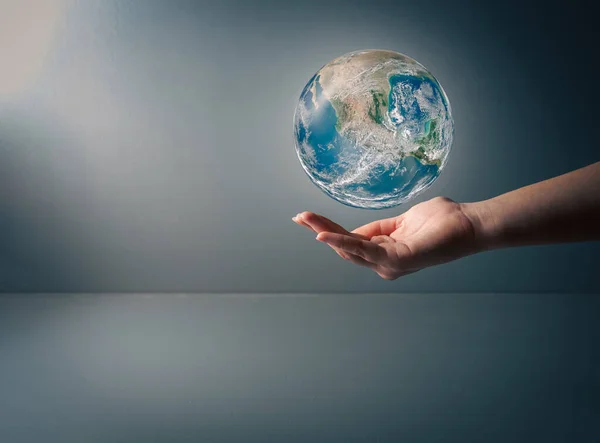 stock image Earth day, Human hand holding blue earth on grey background , save earth conceptel ,ements of this image furnished by NASA , copy space .