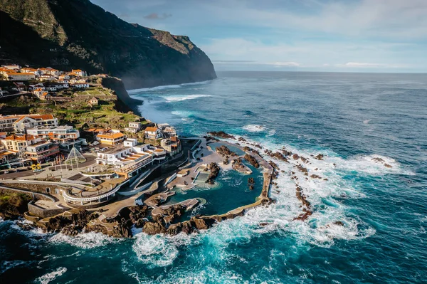 stock image Aerial view of Porto Moniz with volcanic lava swimming pools,Madeira.Saltwater natural pools created in lava formations by Atlantic ocean.Gorgeous views of cliffs and rocky coastline,sunny day