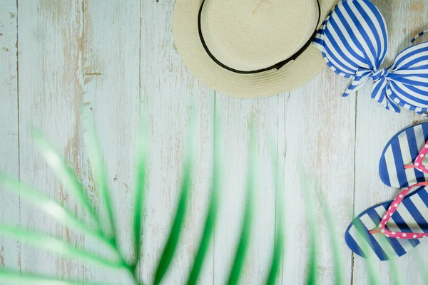 Web afişi ve düz bir yaz mevsimi mayolu ve plaj aksesuarlı klasik mavi ahşap arka planda.