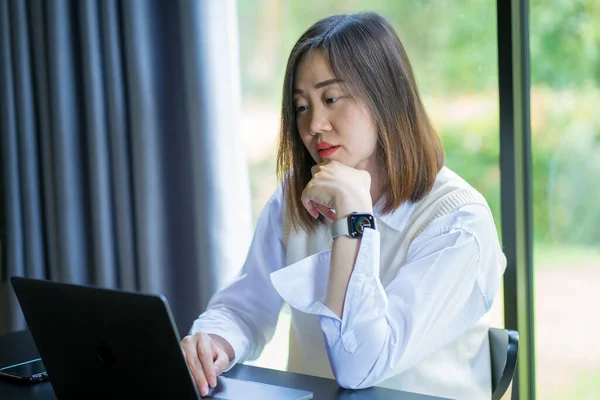 stock image asian freelancer woman use laptop for online meeting with customer from her home