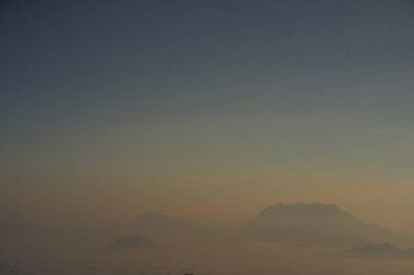 travel and people activity concept with twilight sky before sunrise with mountain and fog on foreground