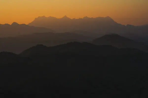 stock image nature traveling with orange sky and layer of mountain with sunrise background