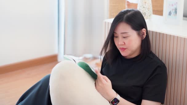 Wellness Wellbeing Concept Asian Woman Lie Read Book Livingroom — Stock Video
