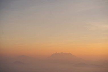 travel and people activity concept with twilight sky before sunrise with mountain and fog on foreground