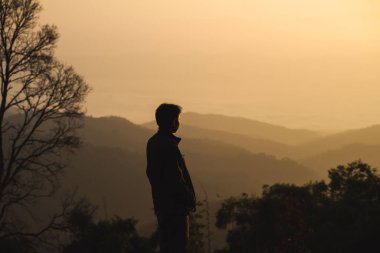 İnsanlarla manzara ve seyahat konsepti sabah gündoğumunu, dağ katmanını ve ormanlı sisi görün.
