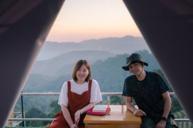 Asyalı çift, balayı seyahatleri ve dağ geçmişiyle rahatlar.