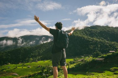 Tek başına seyahat etmek ve dışarıda kamp yapmak. Yağmur mevsiminde Chiangmai Tayland 'da pirinç tarlasında dinlenmek.