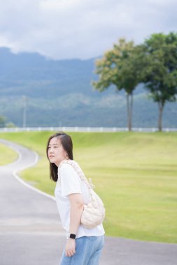 Rahatlayın ve sağlığınıza dikkat edin. Bir kadın yağmur mevsiminde bahçede ve Chiangmai Tayland 'da yolda yürüyor.