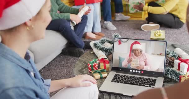 シニアアフリカ系アメリカ人女性とクリスマスビデオ通話をしている友人の多様なグループ 通信技術とクリスマス デジタル複合ビデオ — ストック動画