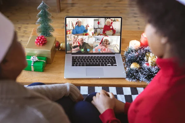 非洲裔美国人夫妇与不同的人有圣诞视频通话 通信技术和圣诞节数字合成图像 — 图库照片