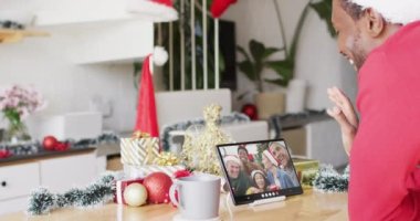 Noel Baba şapkalı Afro-Amerikan bir adamın Noel 'de arkadaşlarıyla yaptığı video görüntülü konuşma. Noel, şenlik, gelenek ve kutlama konsepti dijital olarak oluşturuldu.