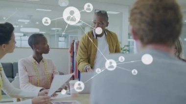 Animation of network of connections over diverse business people in office. Global business and digital interface concept digitally generated video.