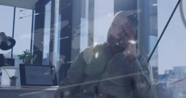 Animation of data processing over caucasian businessman in office. Global business and digital interface concept digitally generated video.
