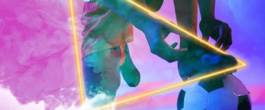 Afrikalı Amerikalıların topa dantel bağlayan alçak kesimi dumanlı arka planda aydınlatılmış üçgenle. Boşluğu kopyala, kompozit, spor, futbol, rekabet, neon, illüstrasyon, parlama ve soyut.