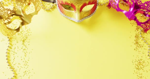 Video Three Masquerade Masks Mardi Gras Beads Confetti Yellow Background — Stock Video