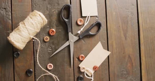 Video Scissors Twine String Buttons Gift Tags Dark Wood Boards — Stock Video