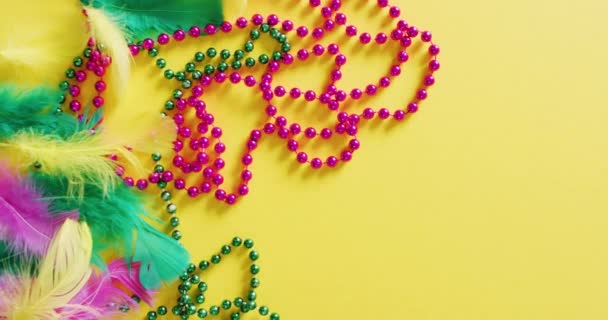Video Pink Green Mardi Gras Carnival Beads Feathers Yellow Background — Stock Video