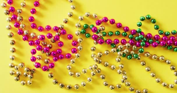 Video Pink Gold Green Mardi Gras Carnival Beads Yellow Background — Stock Video