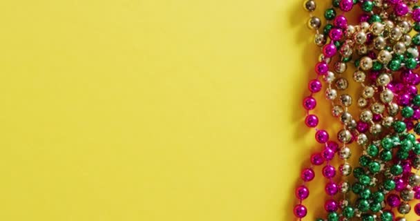 Video Pink Gold Green Mardi Gras Carnival Beads Yellow Background — Stock Video