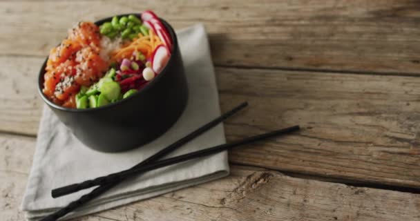 Composition Bowl Rice Salmon Vegetables Chopsticks Wooden Background Food Drink — Stock Video