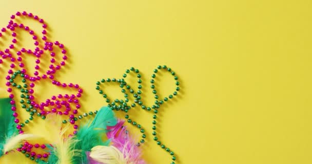 Video Pink Green Mardi Gras Carnival Beads Feathers Yellow Background — Stock Video