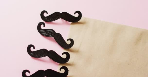 Video Four Black False Moustaches Yellow Envelope Copy Space Pink — Stock Video