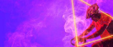 Siyahi erkek bisikletçi, mor arka planda ışıklı üçgen ile bisiklet sürüyor. Boşluğu kopyala, kompozit, spor, rekabet, neon, illüstrasyon, parlama, duman ve soyut kavram.