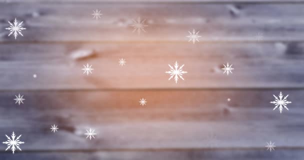 クリスマスのお祭りやお祝いのベクトルイラストやアートコンセプト 黒い背景に浮かぶ複数の雪片アイコンのデジタルアニメーション クリスマスのお祭りや新年のお祝いのベクトルイラストのコンセプト 白木の板 — ストック動画