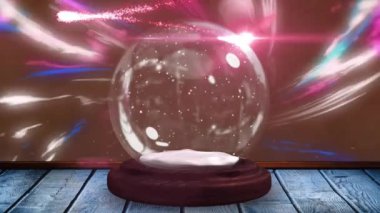 Kar ve kar küresinin üzerindeki hafif noktaların canlandırılması ve mevsimin selamlama metinleri. Noel, gelenek ve kutlama konsepti dijital olarak oluşturuldu.