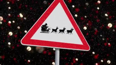 Noel Baba 'nın kızak içindeki animasyonu kırmızı ışık lekelerine karşı ren geyikleri tarafından çekiliyor. Noel şenliği ve kutlama konsepti