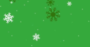 Fotokopi alanı olan yeşil arkaplana düşen kar taneleri simgelerinin canlandırılması. Noel şenliği ve kutlama konsepti