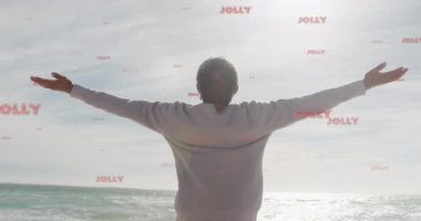 Sahildeki kıdemli çift ırklı adam yerine neşeli metin animasyonu. Noel, kutlama ve dijital arayüz kavramı dijital olarak oluşturulmuş video.