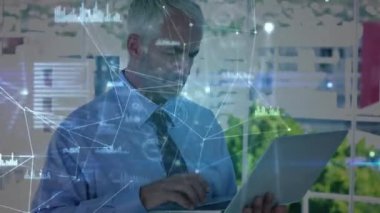 Ofisteki dizüstü bilgisayarla beyaz iş adamının üzerindeki çizgiler ve grafiklerle bağlantılı noktaların animasyonu. Dijital bileşik, çoklu pozlama, rapor, finans, girişimci ve teknoloji kavramı.