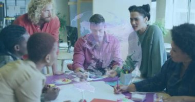 Animation of globe over diverse business people in office. Global business and digital interface concept digitally generated video.
