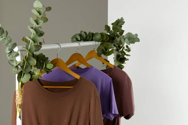 stock image Tshirts displayed on clothing rail and copy space on white background. Clothing, fashion and retail concept.