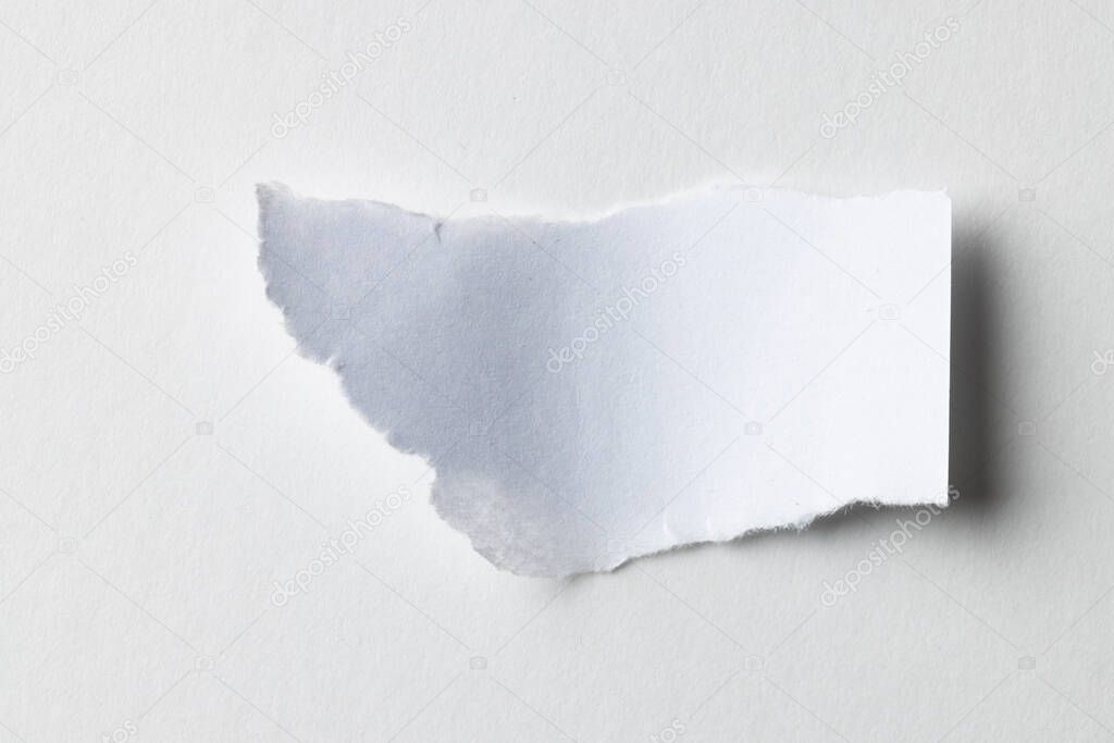 Ripped up piece of white paper with copy space on white background. Abstract paper texture background and communication concept.