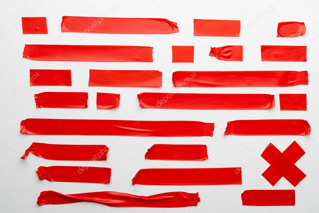 Ripped up pieces of red tape with copy space on white background. Abstract paper texture background and communication concept.