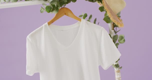 Wideo Bliska Biała Koszulka Wisząca Fioletowym Tle Koncepcja Odzieży Mody — Wideo stockowe
