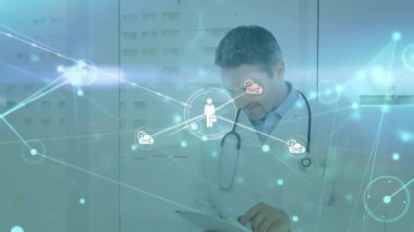 Animation of network of connections with icons over caucasian male doctor. Global medicine, connections and digital interface concept digitally generated video.
