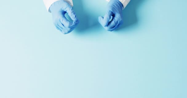 Video Doctor Hands Surgical Gloves Making Heart Shape Blue Background — Stock Video