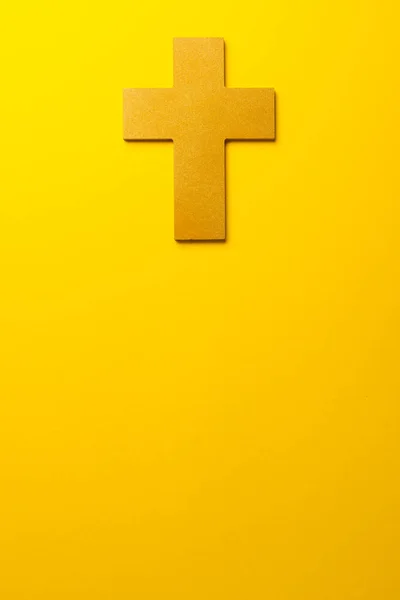 Composition of christian ash wednesday cross on yellow background with copy space. Faith, christianity, celebration and tradition concept.