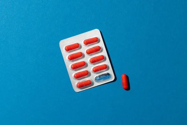 Composition Red Pills Blister Pack One Pill Out Blue Background — Stock Photo, Image