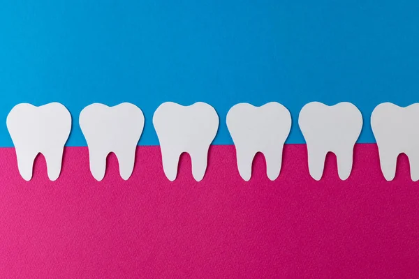 Composition Row White Teeth Pink Gum Blue Background Copy Space — Stock Photo, Image