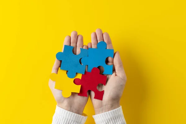 Composition Hands Holding Jigsaw Puzzle Pieces Yellow Background Copy Space — Stock Photo, Image