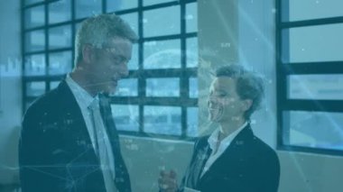 Animation of globe over diverse business people in office. Global business and digital interface concept digitally generated video.