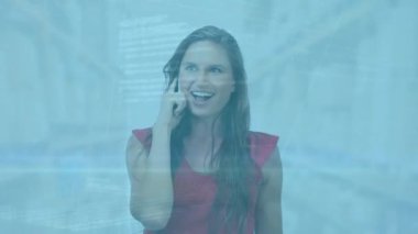 Animation of data processing over caucasian businesswoman talking on smartphone. Global business and digital interface concept digitally generated video.